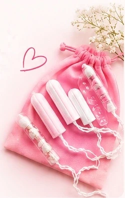 Tampons arranged on a pink drawstring bag